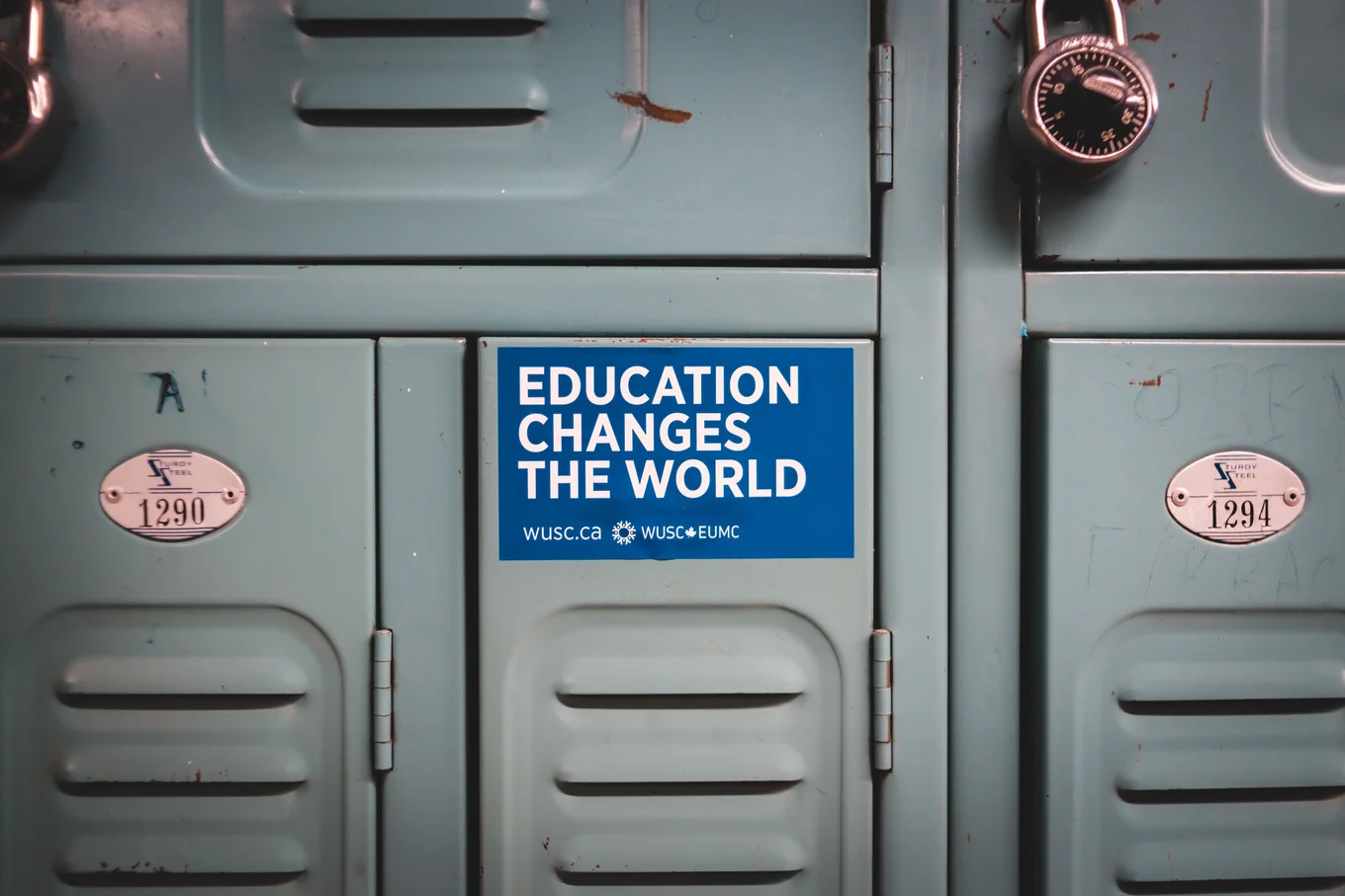 Blue lockers, text "EDUCATION CHANGES THE WORLD."
